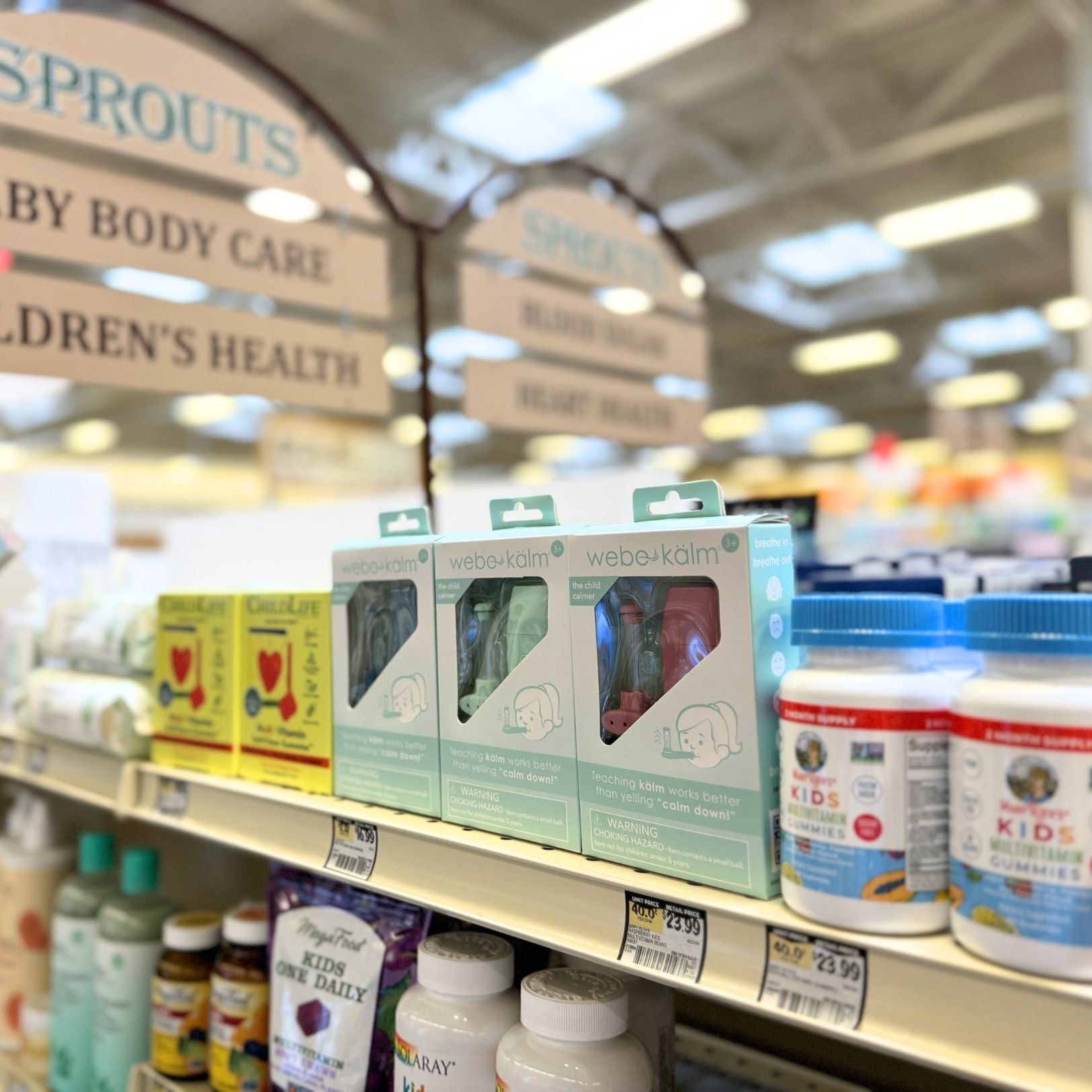 webe kalm with Supplement products on a store shelf with blurred background
